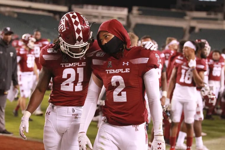 Freddie Johnson, left, and Isaiah Wright of Temple walk off the field after their 63-21 loss to Central Florida at Lincoln Financial Field on Oct. 26, 2019.