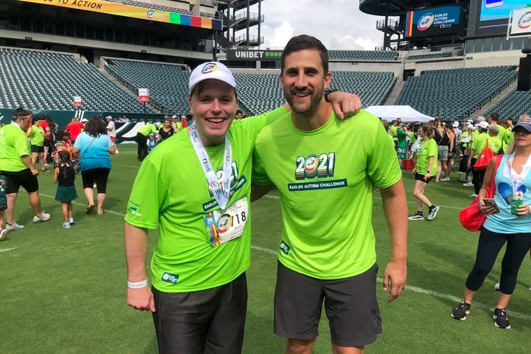 Ryan Lloyd, an active volunteer with the Eagles Autism Foundation, with Eagles head coach Nick Sirianni during the 2021 Eagles Autism Challenge.