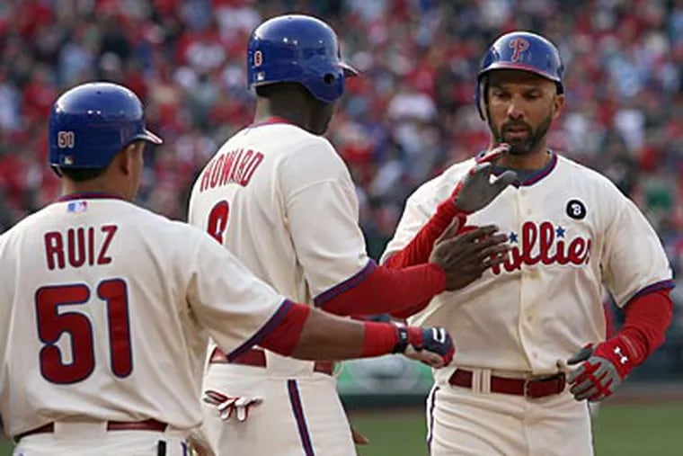 Raul Ibanez celebrates his two-run home run against the Mets with Ryan Howard and Carlos Ruiz. (Yong Kim/Staff Photographer)