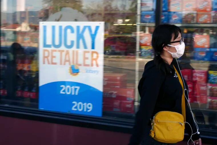 A pedestrian wears a protective mask in Alhambra, Calif., Friday, Jan. 31, 2020. As China grapples with the growing coronavirus outbreak, Chinese people in the Los Angeles area, home to the third-largest Chinese immigrant population in the United States, are encountering a cultural disconnect as they brace for a possible spread of the virus in their adopted homeland.