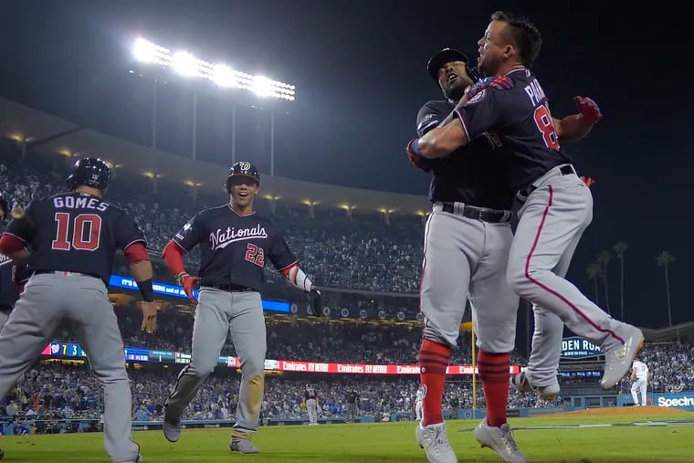 Nationals center fielder Gerardo Parra, right, greets Howie Kendrick after Kendrick hit the game-winning grand slam in the 10th inning of the National League Division Series Game 5 against the Dodgers in Los Angeles on Wednesday night.