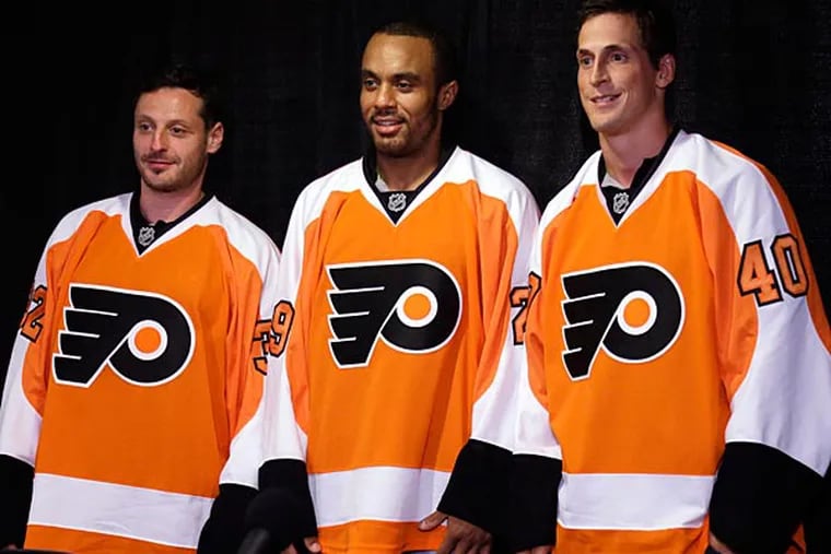 Philadelphia Flyers new acquisitions from left, Mark Streit, Ray Emery, and Vincent Lecavalier pose for photographs during a news conference, Tuesday, July 9, 2013, in Philadelphia. (AP Photo/Matt Rourke)