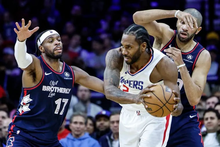 Sixers Buddy Hield left and Nicolas Batum surround Clippers Kawhi Leonard during the 4th quarter at the Wells Fargo Center in Philadelphia, Wednesday, March 27, 2024. Clippers beat the Sixers 108-107.