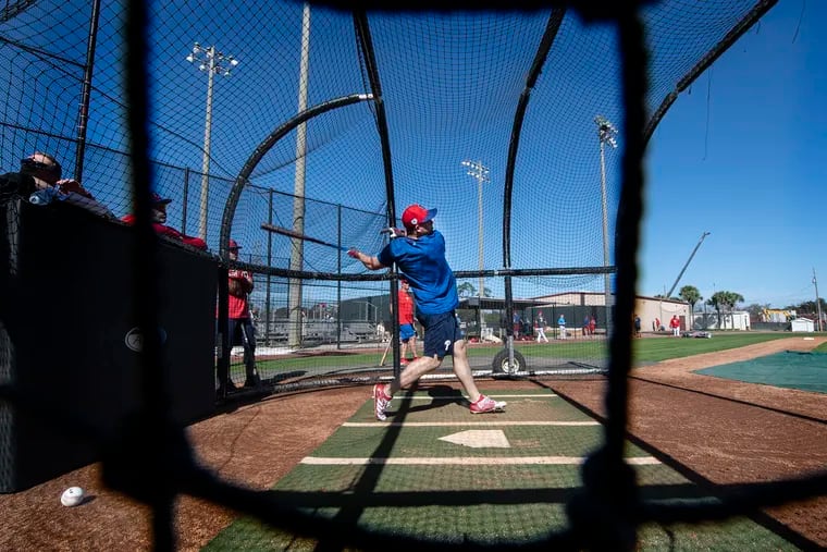 Scott Kingery takes a few pitches during workouts on Monday at the Phillies spring-training complex in Clearwater, Fla.