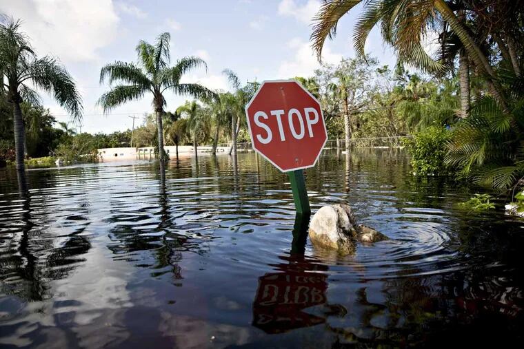 A stop sign stands above flood waters in Bonita Springs, Fla., on Tuesday.