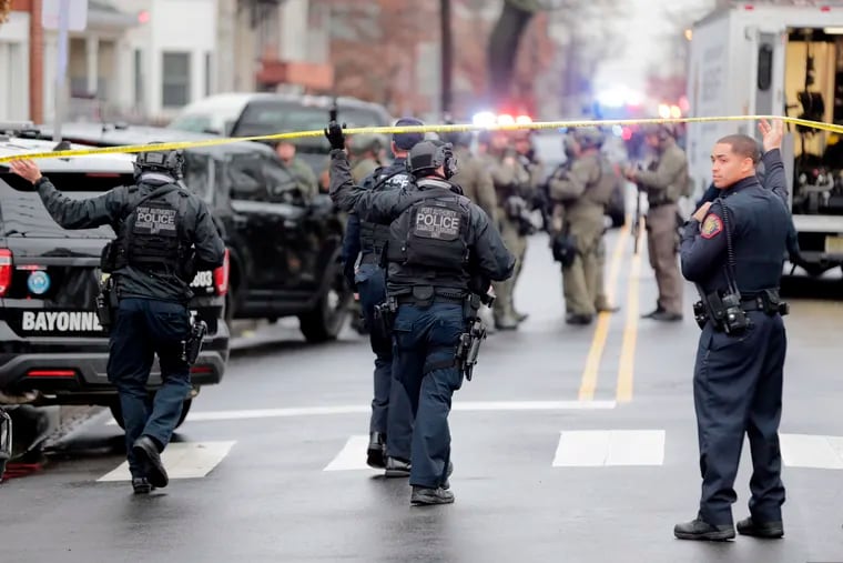 Port Authority Police officers arrive at the scene following reports of gunfire in Jersey City, N.J.