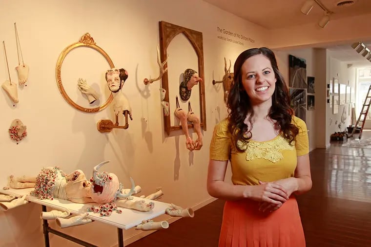 Sara McCorriston, co-founder with Jason Chen of Paradigm Gallery & Studio, stands in front of " The Garden of No Distant Place," ceramics by Sarah Louise Davey in the Paradigm Gallery. ( Michael Bryant / Staff Photographer )