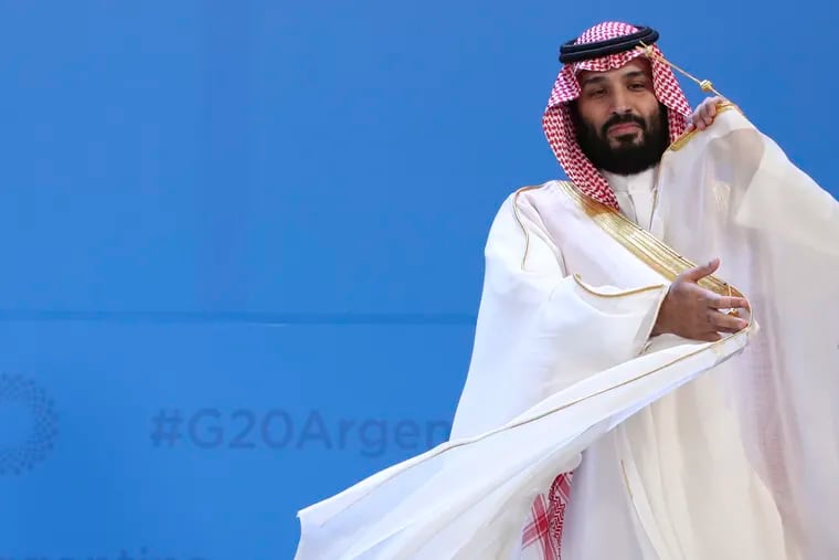 Saudi Arabia's Crown Prince Mohammed bin Salman adjusts his robe as leaders gather for the group at the G20 Leader's Summit at the Costa Salguero Center in Buenos Aires, Argentina, Friday, Nov. 30, 2018. The prince is a controversial figure at the summit, due to the killing of a dissident Saudi journalist in the country's Istanbul consulate. Saudi Arabia denies that bin Salman ordered the killing, but U.S. intelligence agencies have concluded the opposite. (AP Photo/Ricardo Mazalan)