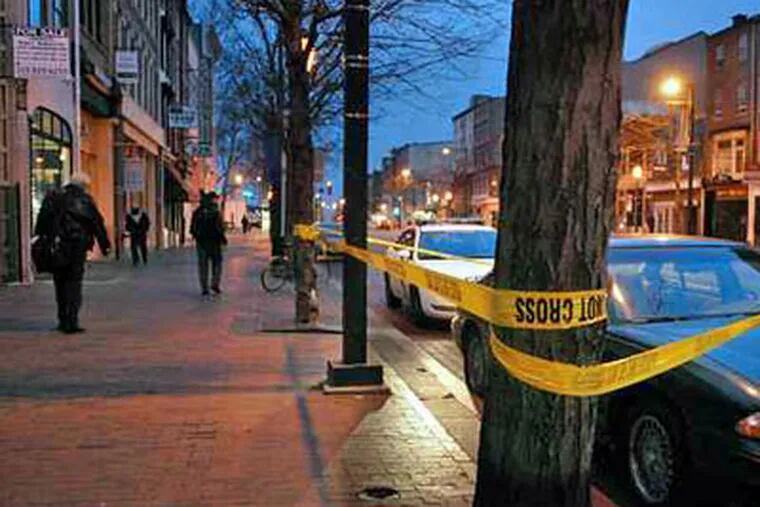 The scene in the 200 block of Market Street before dawn Thursday. Earlier in the morning a man was shot and killed outside the Prive Tapas Restaurant and Lounge in Olde City. (Tom Gralish / Staff Photographer)