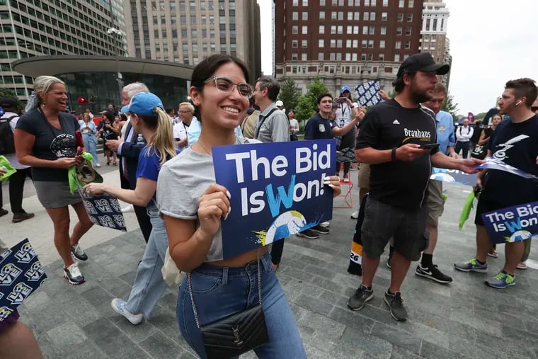 Fans hold signs after learning Philadelphia was named a World Cup 2026 host city at LOVE Park in Center City on June 16.