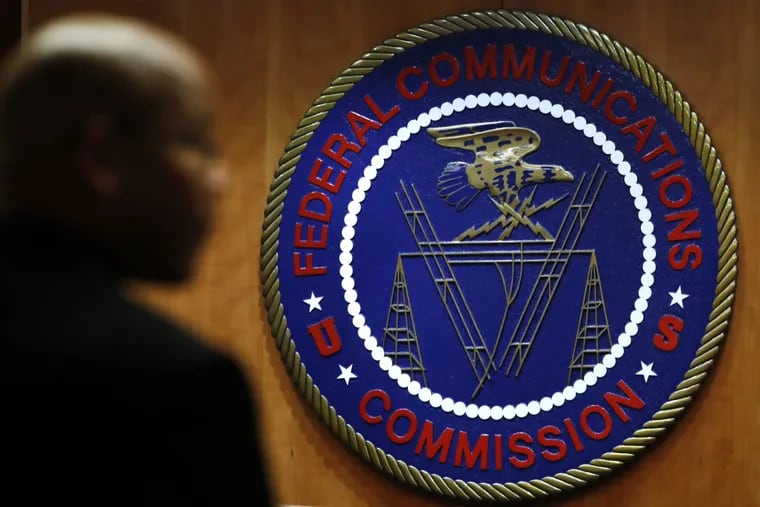 This Thursday, Dec. 14, 2017, photo, shows the seal of the Federal Communications Commission before a meeting in Washington.