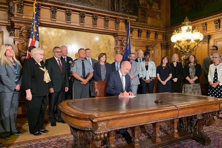 Gov. Tom Wolf signs an executive order Wednesday intending to reform programs for juveniles in state custody.