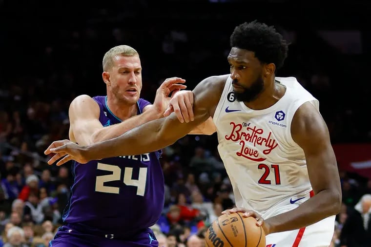 Sixers center Joel Embiid dribbles the basketball against Charlotte Hornets center Mason Plumlee in the second quarter.