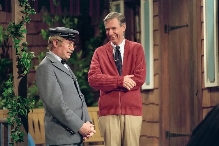 Fred Rogers and David Newell, as Speedy Delivery's Mr. McFeely, stand on the front porch set while filming an episode of "Mister Rogers' Neighborhood."