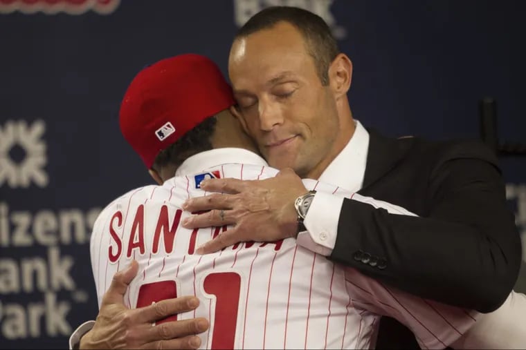 Philadelphia Phillies manager Gabe Kapler, right, embraces with newly signed first baseman Carlos Santana as he was introduced to the media during a press conference at Citizens Bank Park, Philadelphia. Wednesday, December 20, 2017.