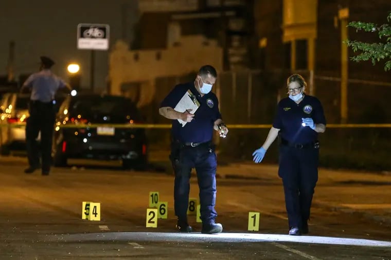 Philadelphia police investigate a triple shooting on the 800 block of South 53rd Street that killed a 28-year-old man and injured his 6-year-old son and another man on Wednesday night. Twelve shell casings were found on the street.