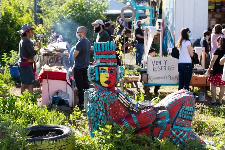 Garden organizers hold a half-day celebration for Workers' Day. In the garden, Mexicans have created an underground oven and sculptures dedicated to Mesoamerican deities of pre-colonial times. Groups perform dances, spoken word, demonstrated coffee brewing, paint crates and t-shirts on May 1, 2021.