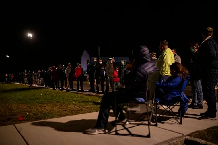 Voters wait in line Tuesday night at Forest Grove Presbyterian Church near Furlong, Bucks County.