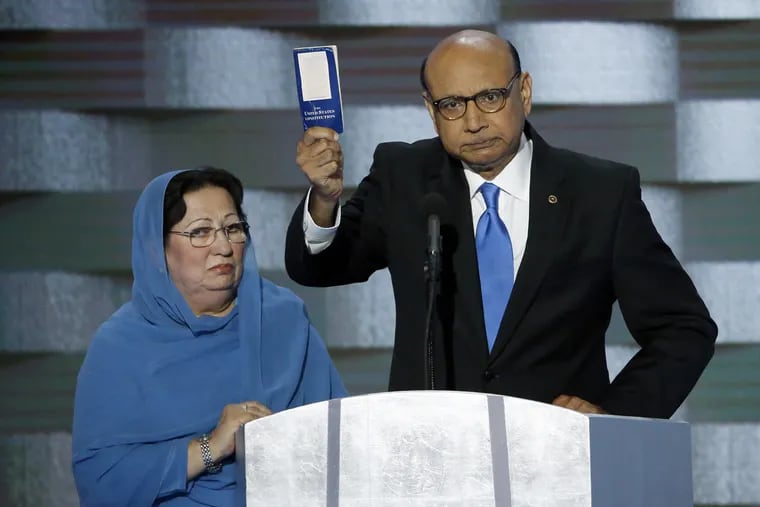 Khizr Khan holds a copy of the Constitution of the United States with his wife Ghazala Khan during the final day of the DNC at the Wells Fargo Center in South Philadelphia on Thursday, July 28, 2016.