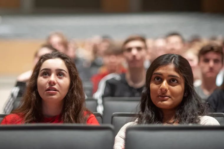 Kelly Roland (left) and Jill Shaw, both 17, listen as Joel Feldman, whose daughter was killed by a distracted driver 10 years ago, speaks with students about the effects of distracted driving at Pennridge High School in Perkasie in April.