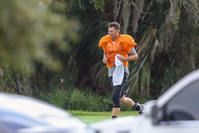 Tampa Bay Buccaneers quarterback Tom Brady running across the field at Berkeley Preparatory School in Tampa. Brady and other Buccaneers players were seen Tuesday working out at the school.