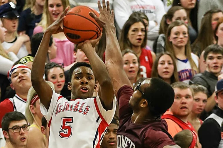 Plymouth Whitemarsh's Xzavier Malone shoots over Lower Merion's Jule Brown during the 3rd quarter of the District 1 AAAA boys' basketball quarterfinal, Friday, February 20, 2015. PW beasts LM 47-36. (Steven M. Falk/Staff Photographer)