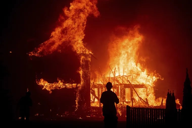 A home burns as the Camp Fire rages through Paradise, Calif.. earlier this month.