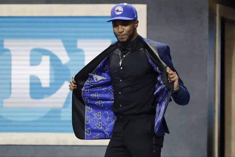 Sixers first round pick Mikal Bridges shows off his Villanova jacket liner with NBA Commissioner Adam Silver during the 2018 NBA draft on Thursday, June 21, 2018 in Brooklyn.