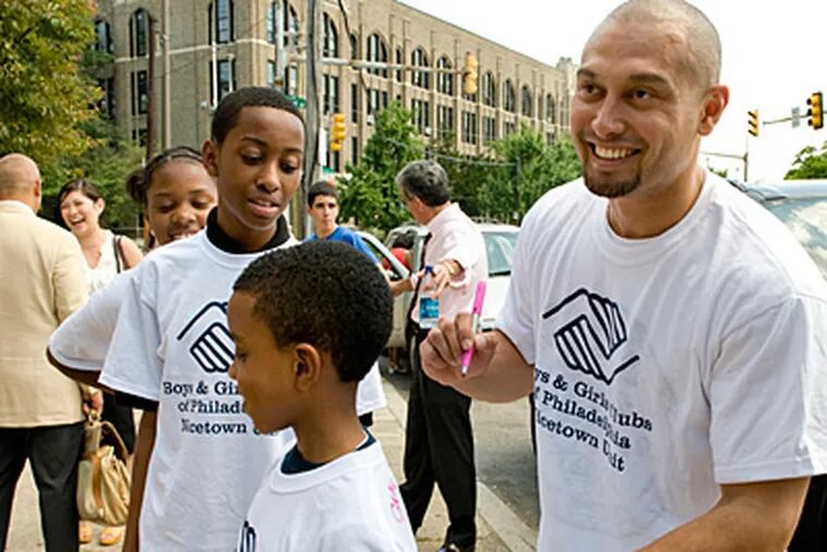 Outside the Nicetown Boys and Girls Club last year, Phillies outfielder Shane Victorino autographed a T-shirt. A gift from Victorino's foundation will help renovate the building. (Clem Murray/File)