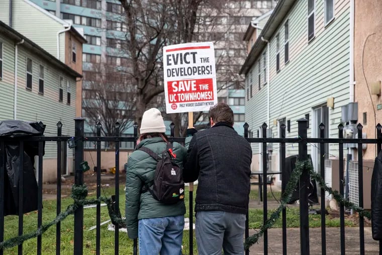 Volunteers put up signage during a gathering at “The People's Townhomes” at 40th and Market Streets in Philadelphia in December.