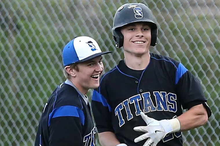 Central Bucks South's Tyler Watson (right) celebrates with Chris Farrell and teammates after his walk-off sacrifice fly to beat North Penn.