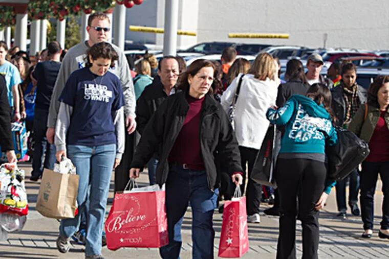 Black Friday shoppers at the King of Prussia Mall, where &quot;We were packed before midnight,&quot; marketing chief Kathy Smith said. By mid-morning, crowds were smaller. ED HILLE / Staff Photographer