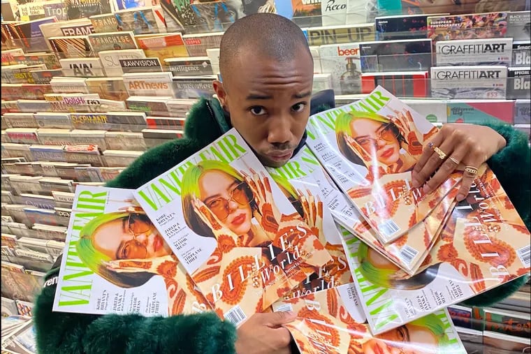 South Philly-born Quil Lemons holds several copies of the March 2021 issue of Vanity Fair, for which he photographed pop singer Billie Eilish for the cover.