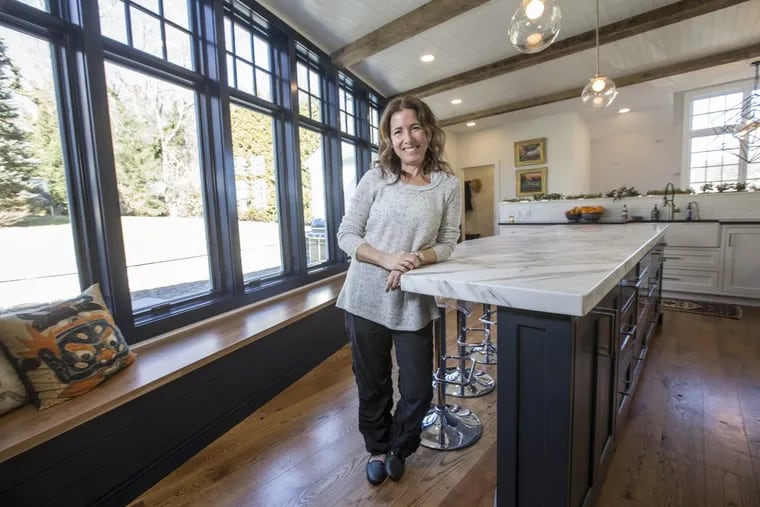 The new kitchen in Erin McDonnell’s Meadowbrook home includes a wall of windows with a view of her yard and new patio.