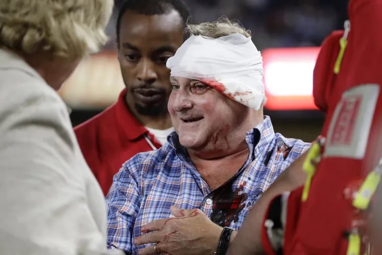 A fan is helped from the stands after being hit by a foul ball during the eighth inning of a baseball game between the New York Yankees and the Cincinnati Reds on July 25 in New York.