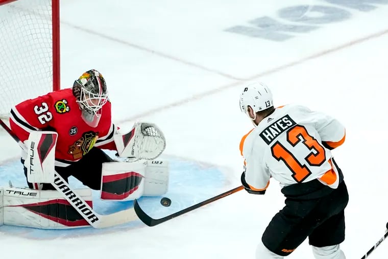 Chicago Blackhawks goaltender Kevin Lankinen (32) makes a save against a shot by Philadelphia Flyers' Kevin Hayes during the second period of an NHL hockey game Monday, April 25, 2022, in Chicago. (AP Photo/Charles Rex Arbogast)