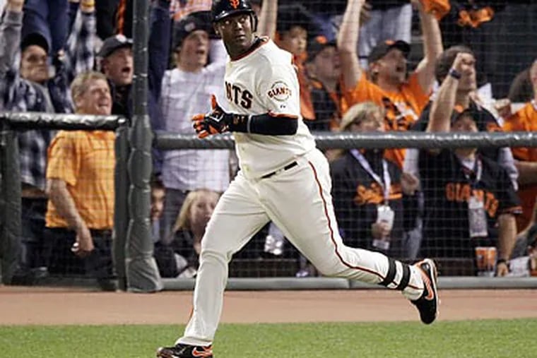 Edgar Renteria watches his fifth-inning home run in Game 2 of the World Series. The Giants won, 9-0. (AP/Eric Gay)