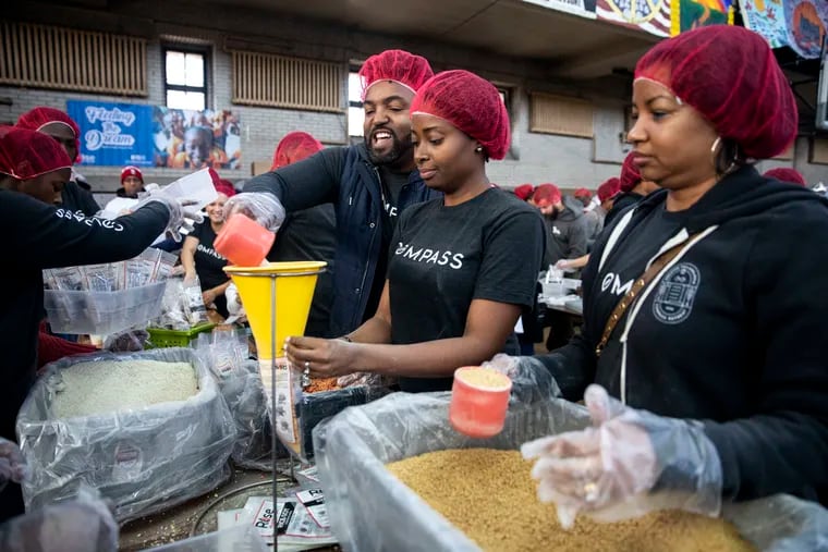 Compass Real Estate employees (from left) Terry Upshur, Cherise Wynne and Danyelle Lowman-Bush fill meal bags for Rise Against Hunger at Girard College in 2020. Compass was ranked No. 1 among large companies in the 2022 Top Workplaces program. Nominations for the 2023 program are open through Jan. 6, 2023.