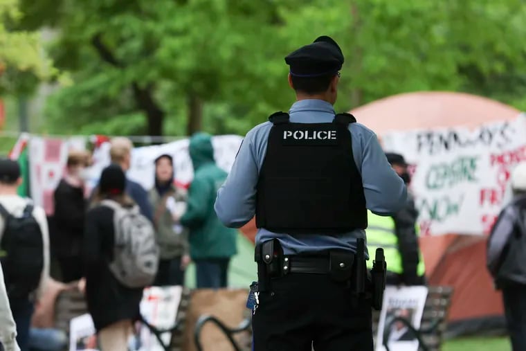 Police standby at the encampment in support of Palestine at College Green on the campus of Penn in Philadelphia on Saturday.