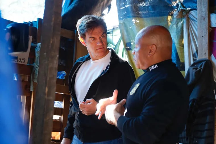 Dr. Oz, left, talks with D.E.A. Special Agent in Charge Gary Tuggle as they tour a heroin encampment in North Philadelphia on April 10, 2017.