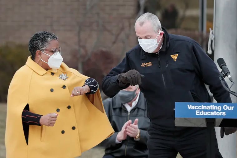 Acting Department of Education Commissioner Dr. Angelica Allen-McMillan and New Jersey Gov. Phil Murphy bump elbows at the Rowan College of South Jersey's COVID-19 vaccination site on March 6 in Deptford.