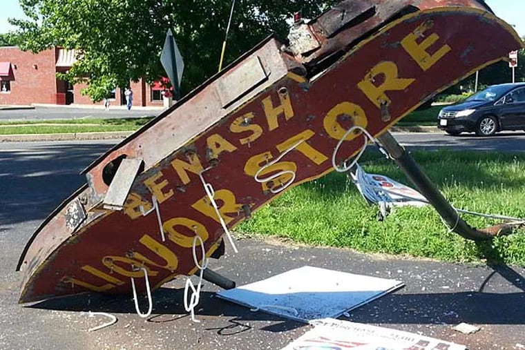The landmark sign for Benash Liqours was struck Friday morning by a pickup truck allegedly driven by off-duty Camden County Police Officer William A. Grasso. The sign has been up for more than 60 years, the store's co-owner says.