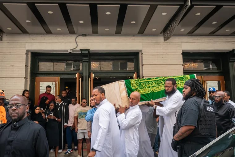 Pallbearers, including Gillie da King (center), carry the coffin of Devin Spady after the Janazah funeral prayer at the Met Philadelphia on Monday morning.