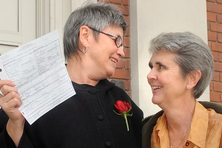 Jody Mock (left) and Beth Kerrigan, both of West Hartford, Conn., share a moment at town hall after receiving their marriage license.