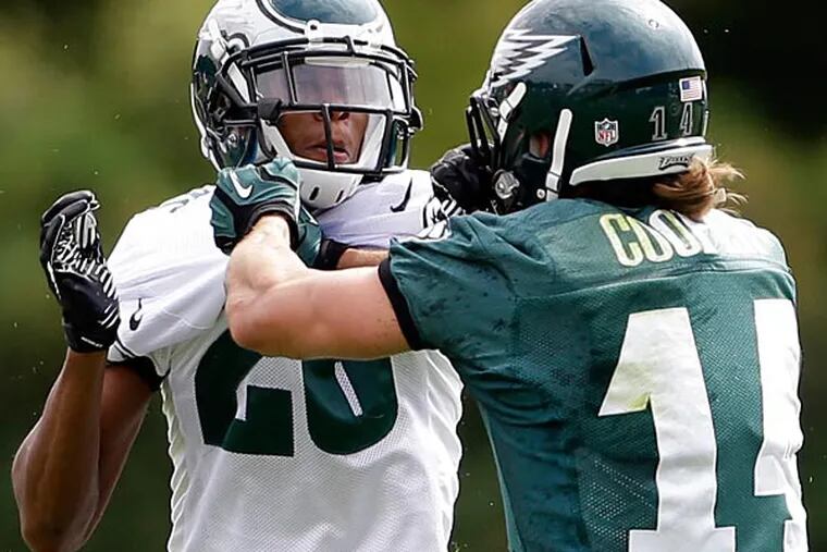 Eagles cornerback Cary Williams and Riley Cooper push each other during practice. (Matt Rourke/AP)