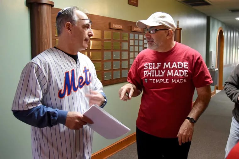 Samuel Domsky (right), who directs 400 volunteers at Temple Sinai in Dresher to deliver Passover food to  600 needy families, confers with Steven Pilchik of Huntingdon Valley, who plans the delivery routes. Domsky's done his Passover mitzvah for 20 years.