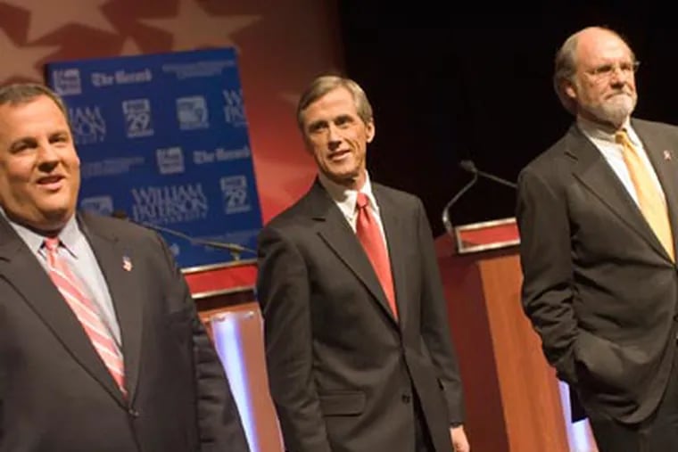 Republican Chris Christie, Independent Chris Daggett, and Democrat incumbent Gov. Jon Corzine meet the audience prior to a final debate held at William Paterson University. (AP Photo/Christopher Barth)