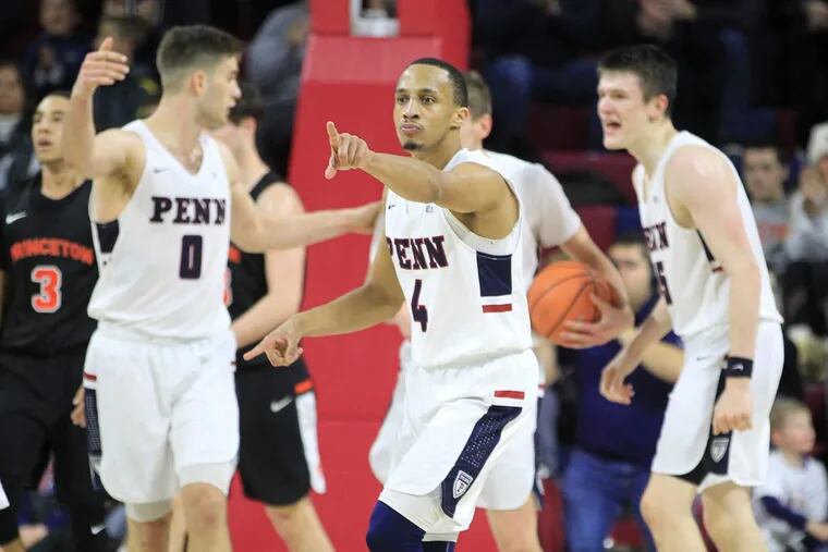 Darnell Foreman, center, of Penn points to his teams bench as drew a foul to clinch their 76-70 victory over Princeton at the Palestra on Jan 6, 2018.