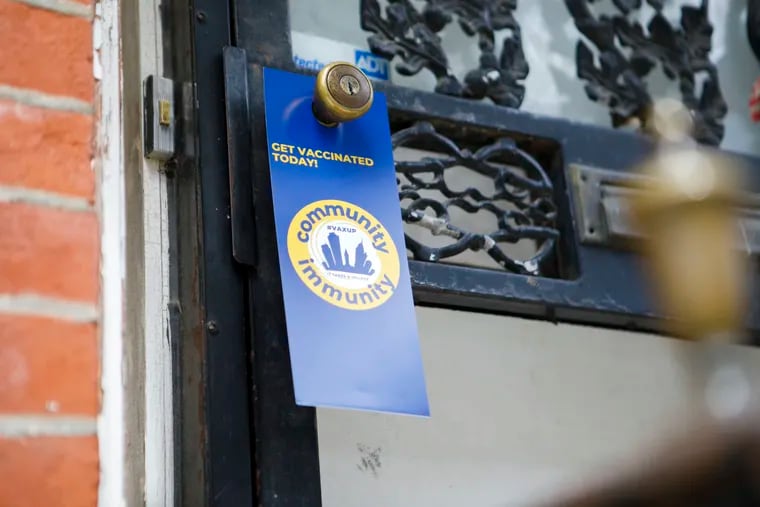 A flier is left at a door in the North Philadelphia neighborhood incentivizing people to get vaccinated in June.