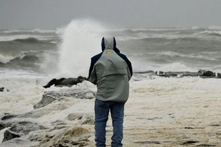 Sea foam spills over a jetty in Longport as Hurricane Sandy approaches on October 28, 2012.( Michael S. Wirtz / Staff Photographer )